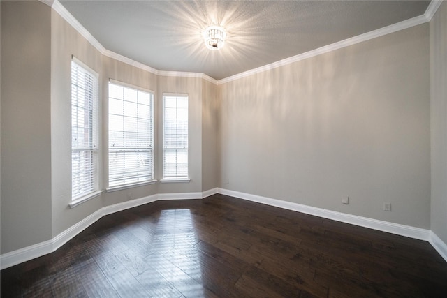 empty room with crown molding, baseboards, and dark wood-style flooring