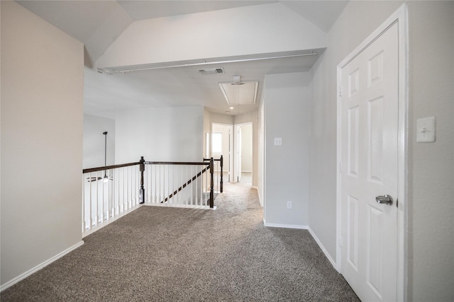 corridor featuring attic access, carpet flooring, an upstairs landing, and baseboards