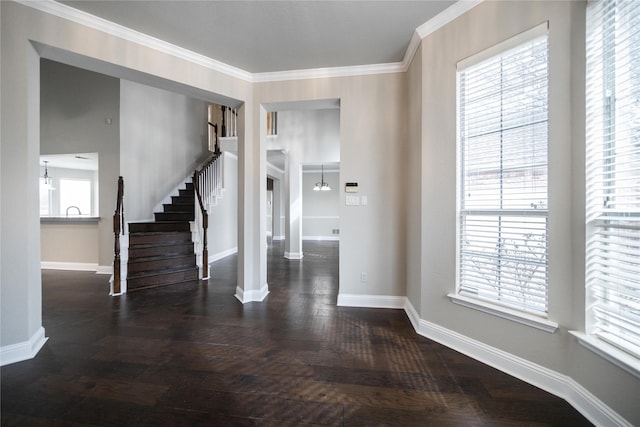 entrance foyer with stairway, ornamental molding, baseboards, and dark wood-style flooring