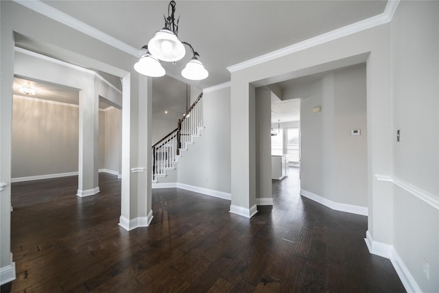 unfurnished dining area with crown molding, stairway, wood finished floors, and baseboards