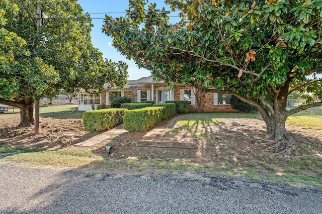 obstructed view of property with brick siding