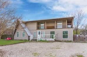 back of property with covered porch