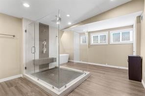 workout room featuring recessed lighting, baseboards, and wood finished floors