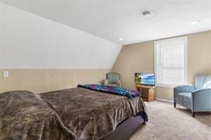 carpeted bedroom featuring lofted ceiling