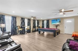 rec room with a ceiling fan, billiards, and wood finished floors