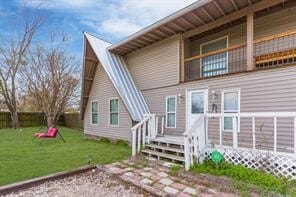 rear view of property featuring a yard