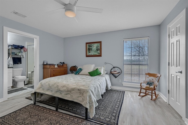 bedroom featuring baseboards, visible vents, light wood finished floors, and ceiling fan