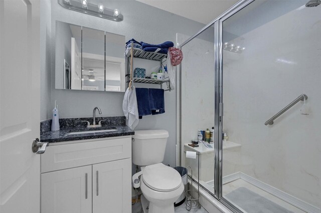 full bath featuring toilet, a stall shower, and vanity