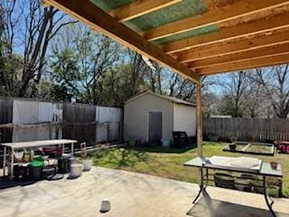 view of patio featuring an outbuilding and a fenced backyard