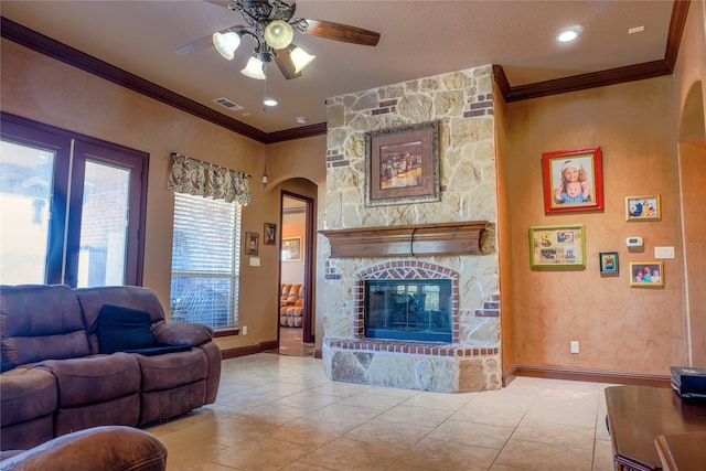 living area with tile patterned flooring, a fireplace, visible vents, and ornamental molding