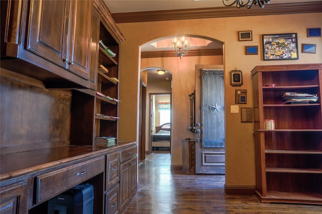 home office with baseboards, an inviting chandelier, arched walkways, ornamental molding, and dark wood-type flooring