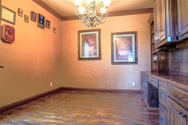 unfurnished dining area with a notable chandelier, dark wood-style floors, baseboards, and ornamental molding