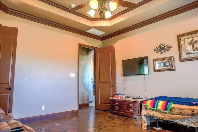 bedroom featuring crown molding, baseboards, wood finished floors, a raised ceiling, and a ceiling fan