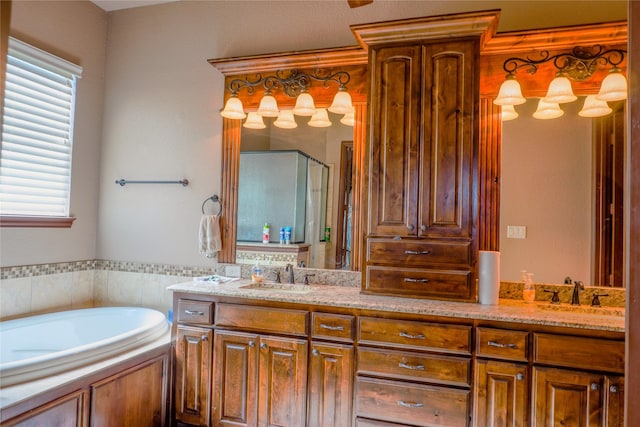 bathroom with a sink, a shower stall, a bath, and double vanity