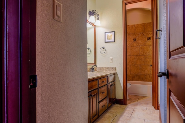 bathroom featuring tile patterned flooring, toilet, vanity, and shower / bath combination