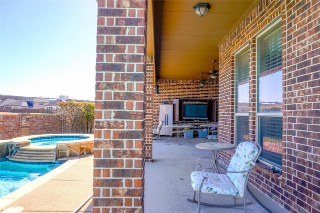 view of patio featuring a fenced in pool and an in ground hot tub