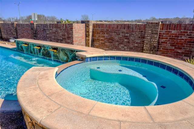 view of pool featuring an in ground hot tub, fence, and a fenced in pool