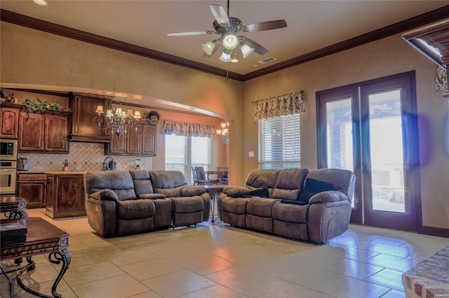 living area with light tile patterned floors, visible vents, ceiling fan with notable chandelier, and ornamental molding