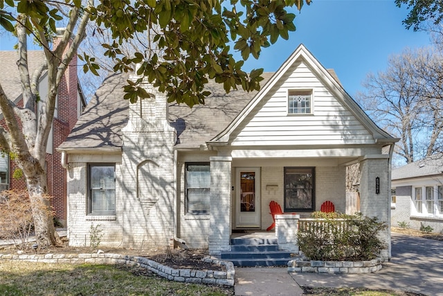 view of front of property featuring covered porch and brick siding