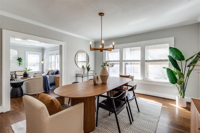 dining room with a healthy amount of sunlight, ornamental molding, and wood finished floors