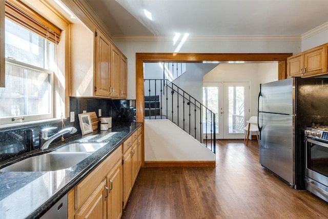 kitchen featuring a sink, stainless steel appliances, ornamental molding, and french doors