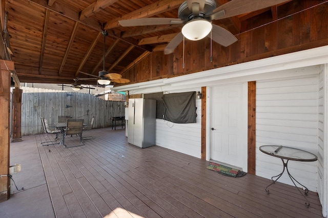 wooden deck with a ceiling fan and fence