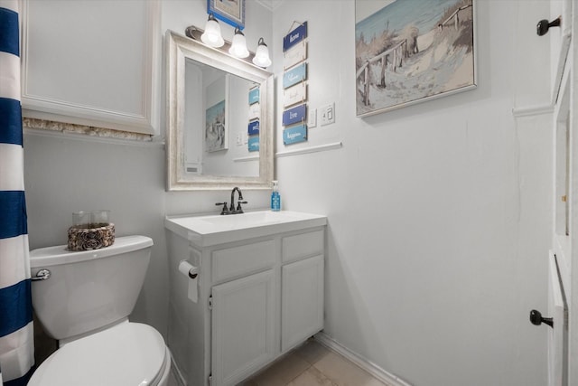 bathroom featuring tile patterned floors, toilet, vanity, and baseboards