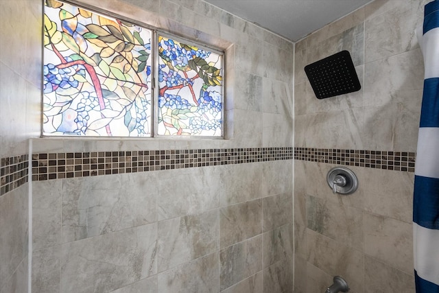 bathroom with a tile shower