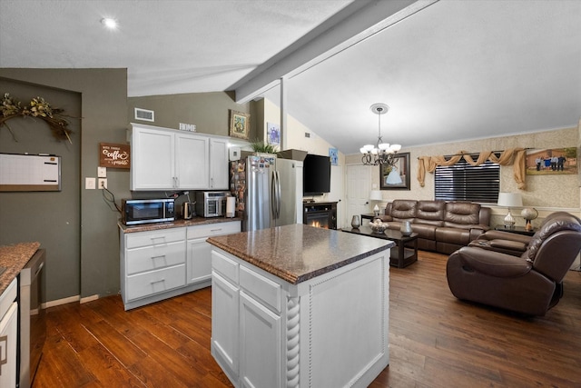 kitchen with lofted ceiling with beams, open floor plan, white cabinetry, stainless steel appliances, and dark wood-style flooring