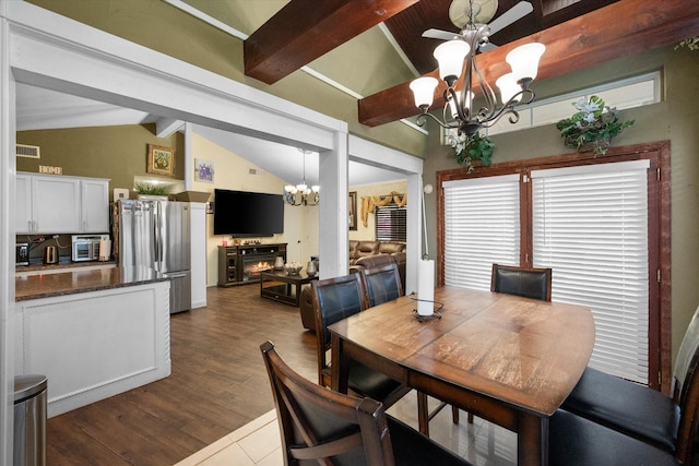 dining room featuring visible vents, a notable chandelier, dark wood-style flooring, and vaulted ceiling with beams