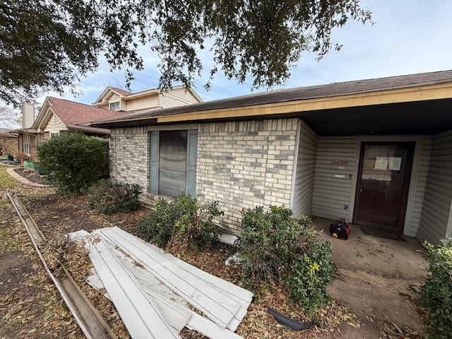 property entrance with brick siding