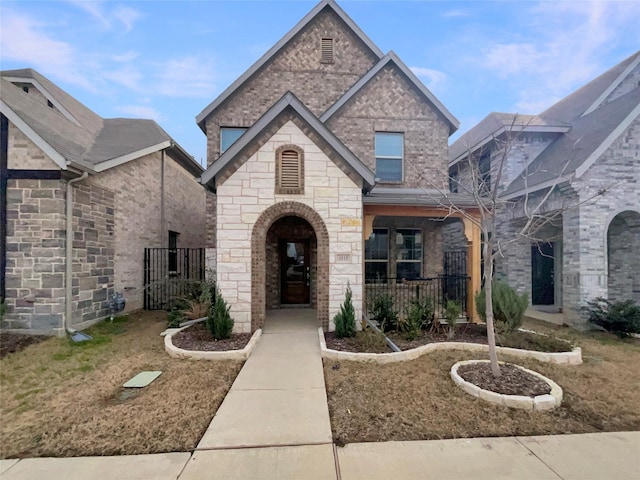 view of front facade with brick siding and stone siding