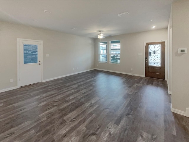 foyer entrance featuring visible vents, a ceiling fan, baseboards, and dark wood-style flooring