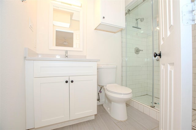 full bath with a shower stall, toilet, and vanity