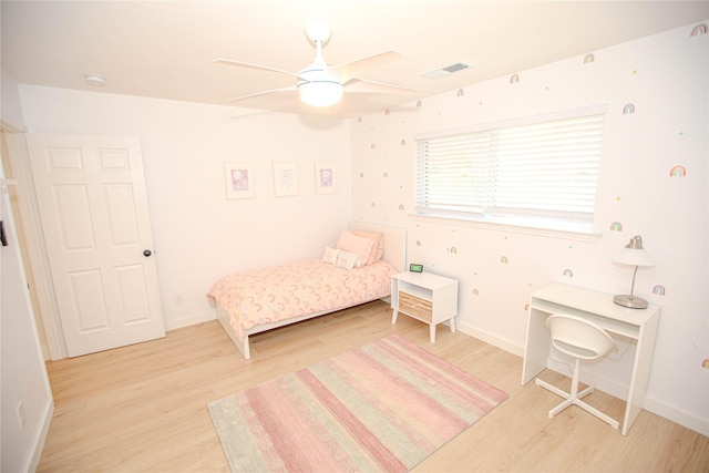 bedroom featuring visible vents, baseboards, light wood-style flooring, and a ceiling fan