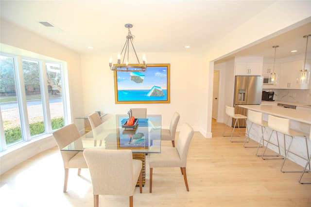 dining room with baseboards, visible vents, an inviting chandelier, light wood-style flooring, and recessed lighting