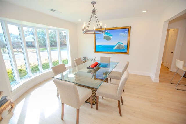 dining space featuring light wood-type flooring, visible vents, a notable chandelier, recessed lighting, and baseboards