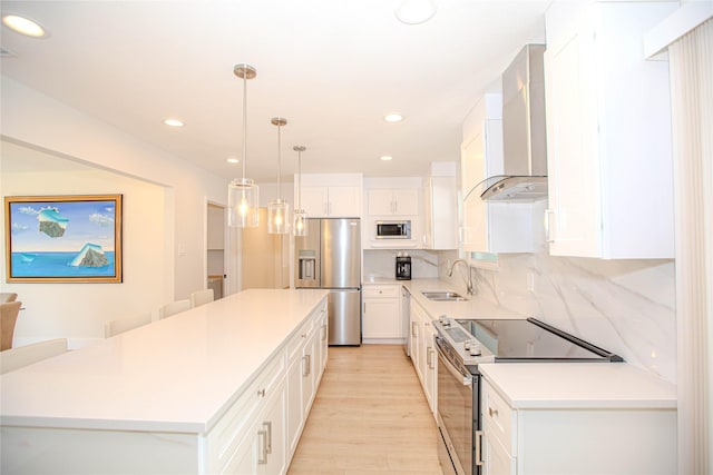 kitchen featuring a sink, a center island, stainless steel appliances, wall chimney exhaust hood, and decorative backsplash