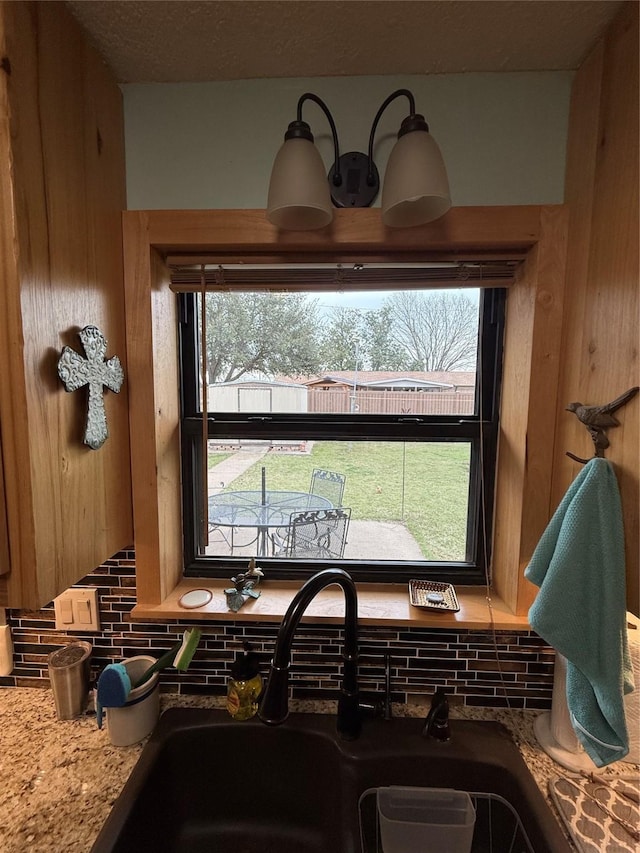 interior details featuring tasteful backsplash and a sink