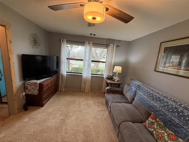 living room featuring light colored carpet and ceiling fan