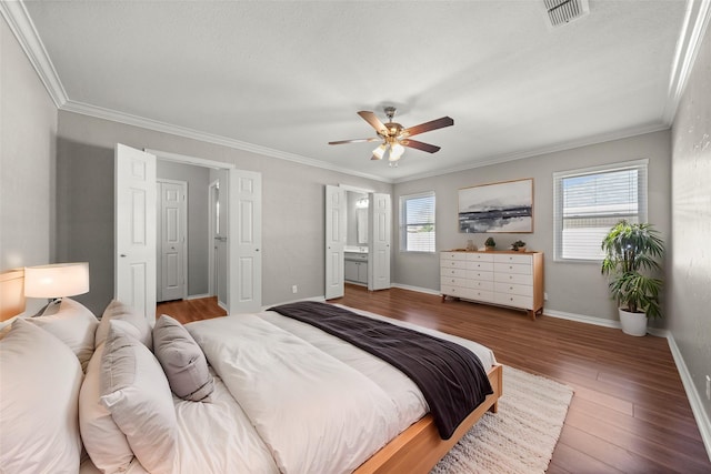 bedroom with visible vents, multiple windows, ornamental molding, and wood finished floors