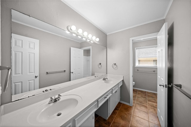 bathroom featuring ornamental molding, toilet, double vanity, and a sink