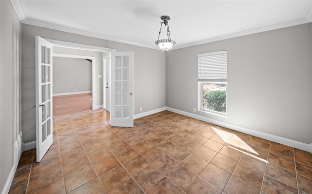 unfurnished room with french doors, baseboards, dark tile patterned flooring, and crown molding