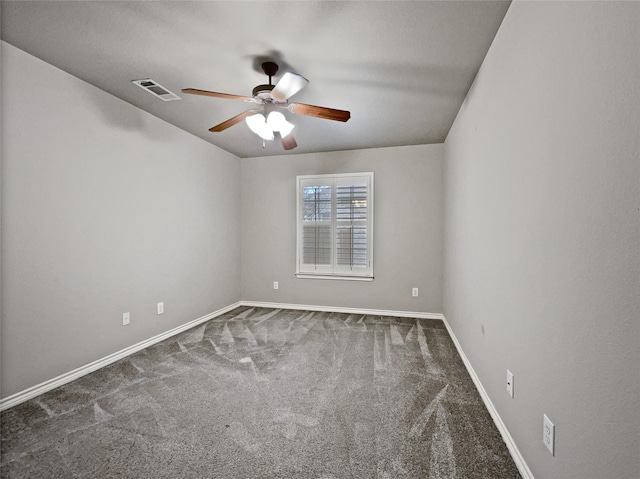 spare room with visible vents, carpet flooring, baseboards, and ceiling fan