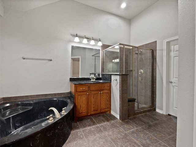 full bathroom featuring a bath, tile patterned flooring, a shower stall, and vanity