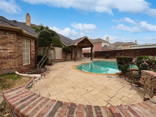 view of swimming pool featuring a fenced in pool, a patio, and a fenced backyard