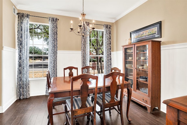 dining room featuring an inviting chandelier, dark wood-style floors, wainscoting, and ornamental molding