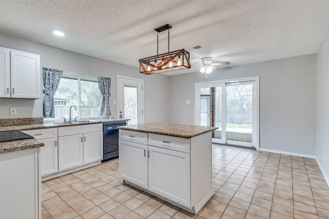 kitchen featuring visible vents, a sink, black dishwasher, white cabinets, and light tile patterned floors