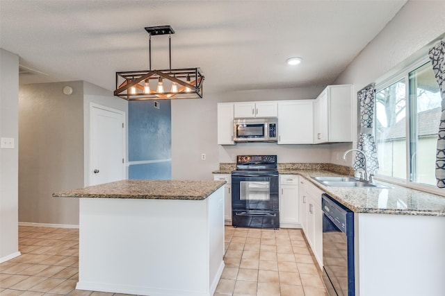 kitchen with black appliances, a sink, a center island, light tile patterned flooring, and light stone countertops