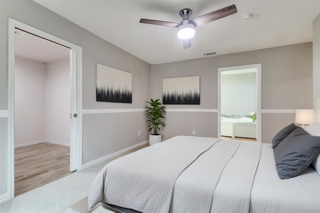 bedroom with a ceiling fan, carpet flooring, baseboards, and visible vents